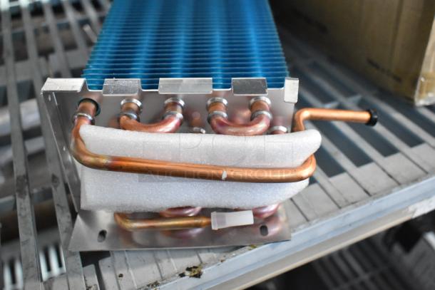 BRAND NEW Avantco 17815282HC evaporator coil for A-12 units. Copper piping, foam padding, minor scratches visible.