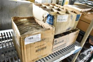 Three boxes of new scratch and dent items: E0583 plates, Corona ramekins, Libbey 3620JS glasses. Boxes labeled with product details.