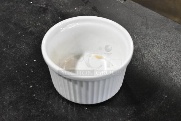 Bright white fluted porcelain ramekin with ribbed texture, 6.8 oz, brand new, minor scratch visible inside.