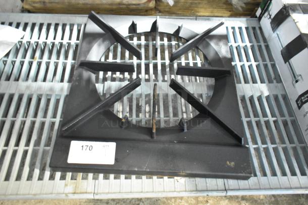 BRAND NEW SCRATCH AND DENT single burner range grate. Features a robust metal build, slight imperfections present. Quantity tag visible. Ideal for stove replacement.