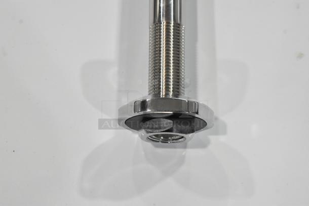 Brand new metal water faucet with visible scratches and dents, featuring a threaded base and chrome finish.