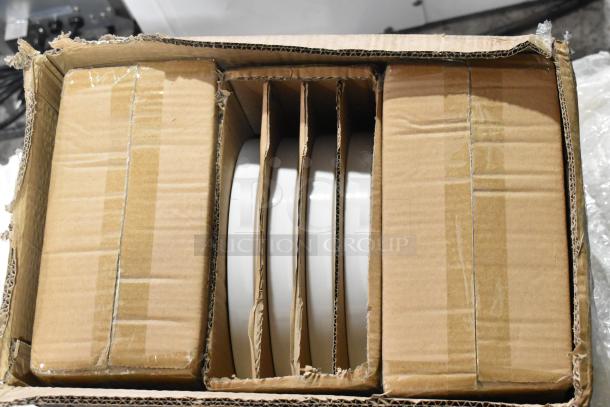 Box containing 4 brand new Acopa porcelain plates with scratch and dent condition, securely packed in cardboard.