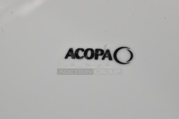 "Acopa" logo on white porcelain surface, part of 303SCD9WH Acopa Lore 9 1/4" raised rim plate.