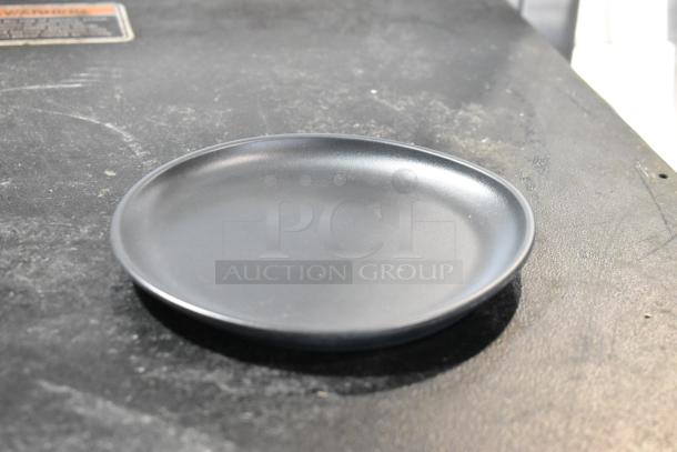 Dark gray irregular round melamine coupe plate, 6" diameter, matte finish, by GET Enterprises. Brand new condition.