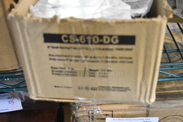 Box labeled "CS-610-DG" containing new 6" dark gray GET Enterprises Riverstone plates. Slight box damage visible.