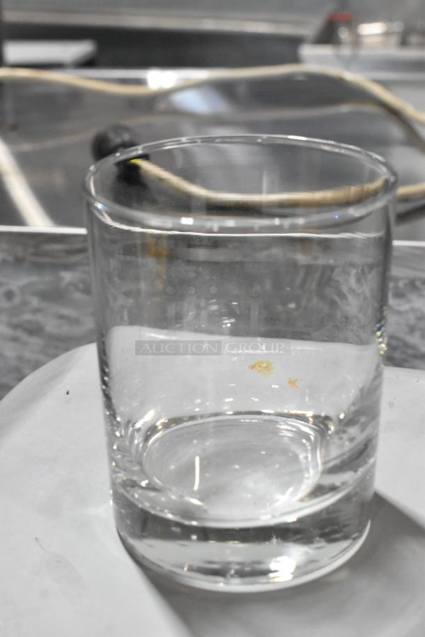 Libbey 918CD Heavy Base 13.5 oz. Rocks glass, clear, new with slight scratch and dent, on a kitchen counter.