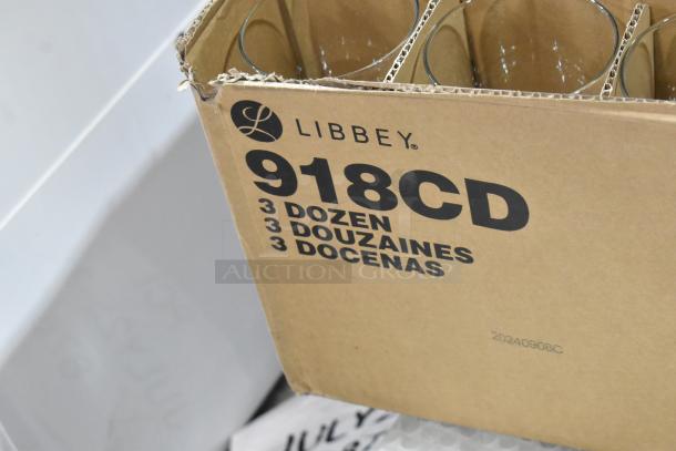 Cardboard box of Libbey 918CD Heavy Base 13.5 oz. Glasses, labeled "3 Dozen." Box partially opened showing glass rims.