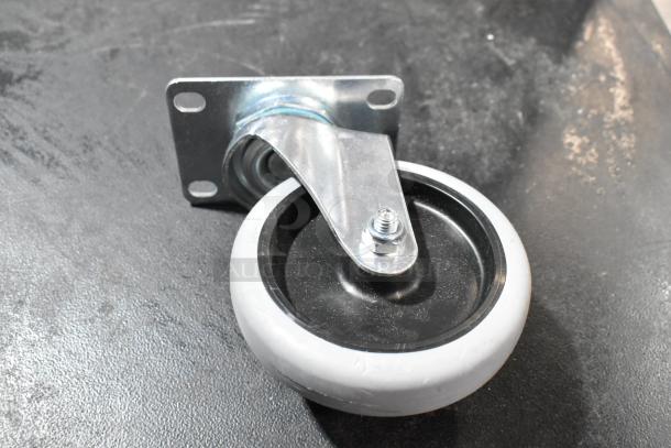 Lot of 4 commercial casters, brand new with minor scratches, featuring metal brackets and rubber wheels. Ideal for heavy-duty use.