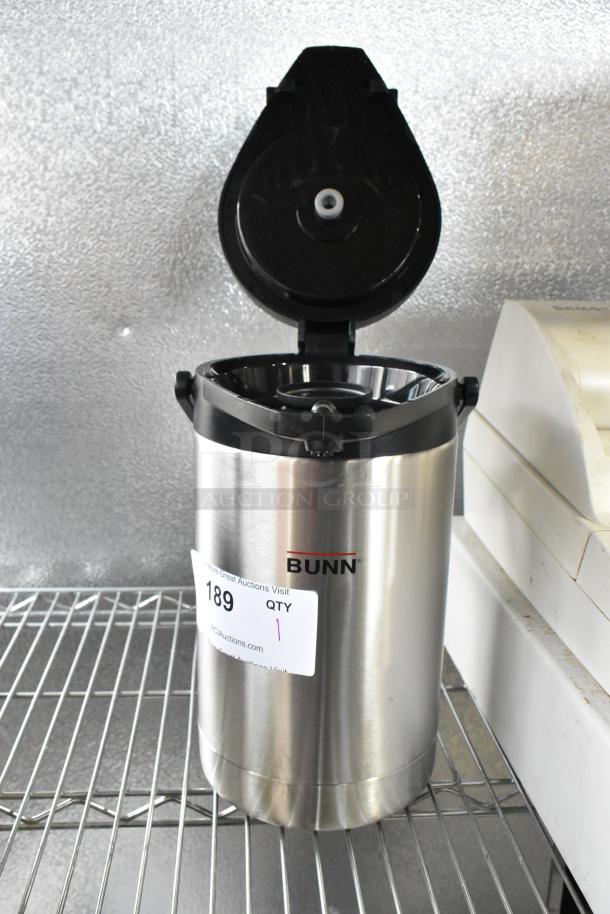Bunn Stainless Steel Air Pot with open lid, shown on a wire shelf. Features auction tag with item number 189.