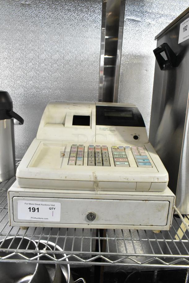 Sam4S ER-521SM electronic cash register, cream-colored, keypad visible, used condition, label indicating model.