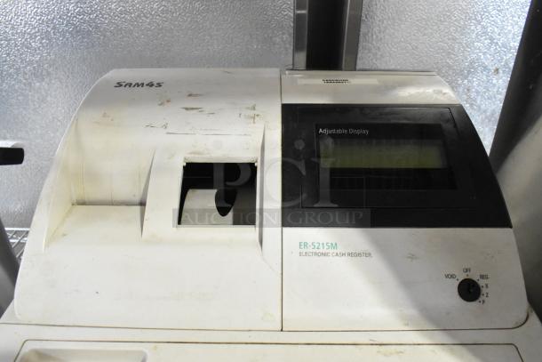 Sam4S ER-521SM Cash Register, white, countertop model with adjustable display. Shows signs of use; includes visible markings.