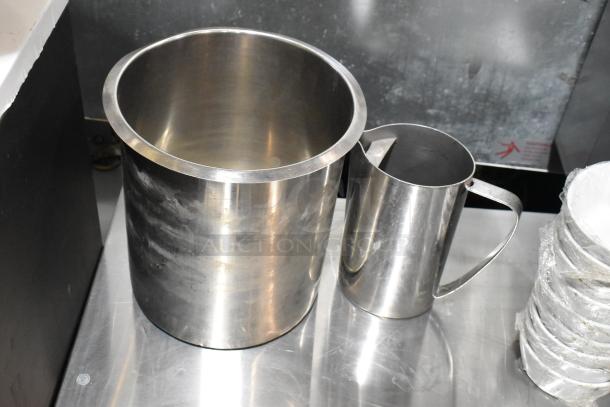 Stainless steel ice bucket and pitcher on metal surface, showcasing durable construction and modern design.