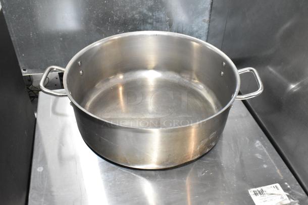 5 metal stock pots, stainless steel, used condition, handles on sides. Sturdy, suitable for large quantity cooking.