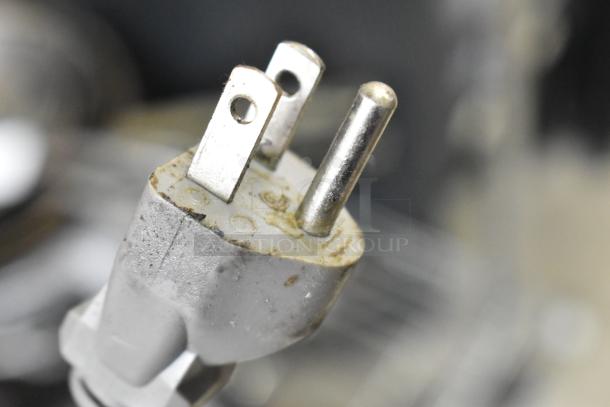 Close-up of Panasonic NN-SU696S microwave oven plug, showing signs of wear. Model operates on 115 volts, 1 phase.