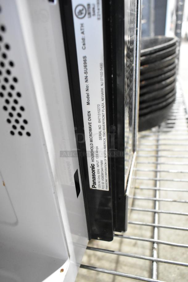 Panasonic NN-SU696S countertop microwave oven label, 115 volts, 1 phase; visible serial and model number for verification.