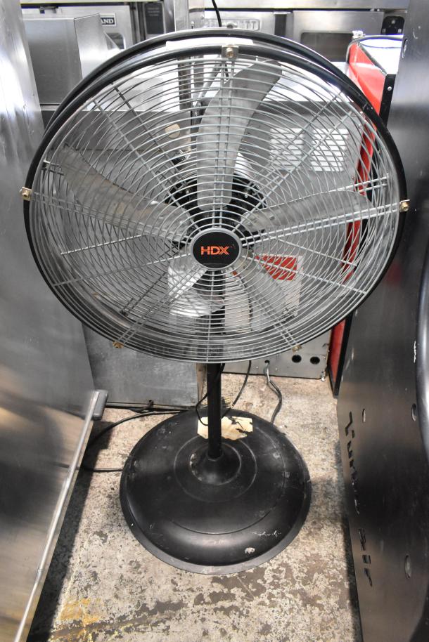 HDX SFSD1-500B3W metal floor fan, 120V, 1 phase, black stand, visible signs of wear, ideal for industrial use.