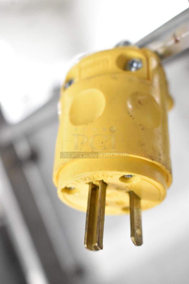 Close-up view of a yellow plug connector for the HDX SFSD1-500B3W Metal Floor Fan, 120 volts, 1 phase.