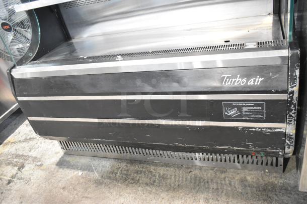 Turbo Air TOM-50B metal open merchandiser, black finish, metal shelves, 120V, 1 phase, with visible wear and maintenance label.