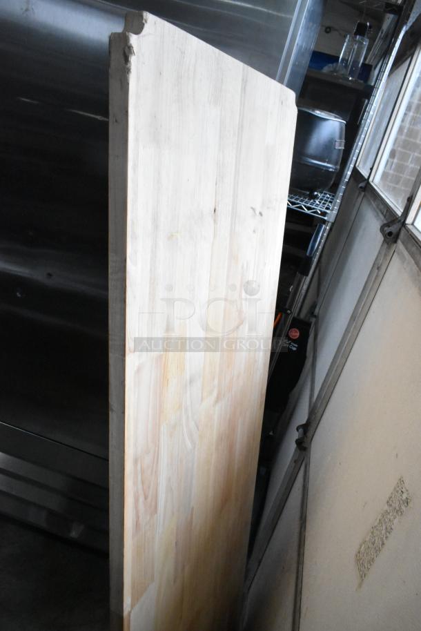 Wooden under shelf cover, light-colored wood, showing grain texture. Edges slightly worn, indicating prior use.