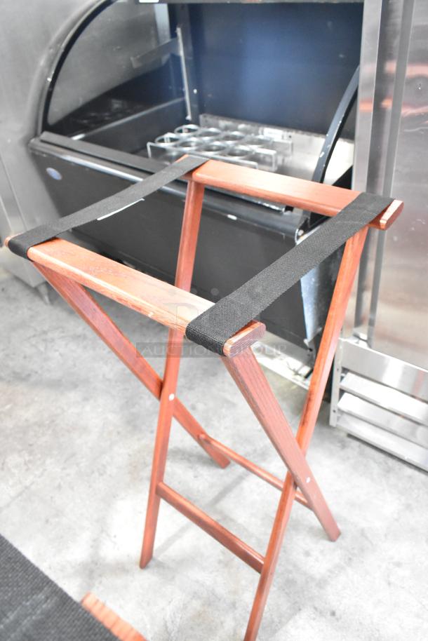 Four wooden folding serving tray stands, sturdy construction, smooth finish, black straps, excellent condition.