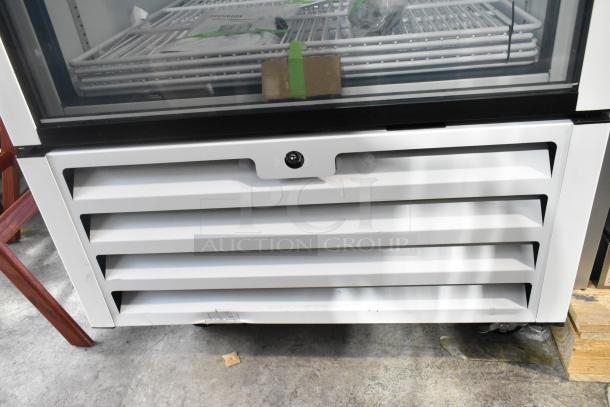 Accucold AFG26MLLH metal commercial reach-in cooler with single glass door, poly-coated racks, commercial casters, 115V.