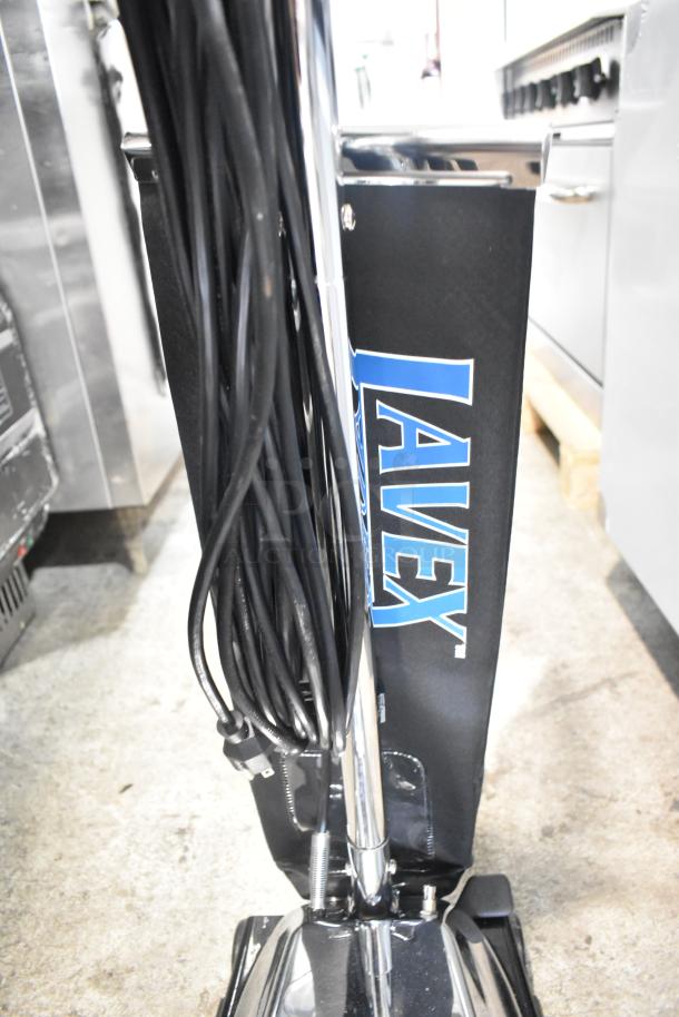 Lavex P101 vacuum cleaner, 120 volts, upright design, chrome body, visible cord, appears in good condition.