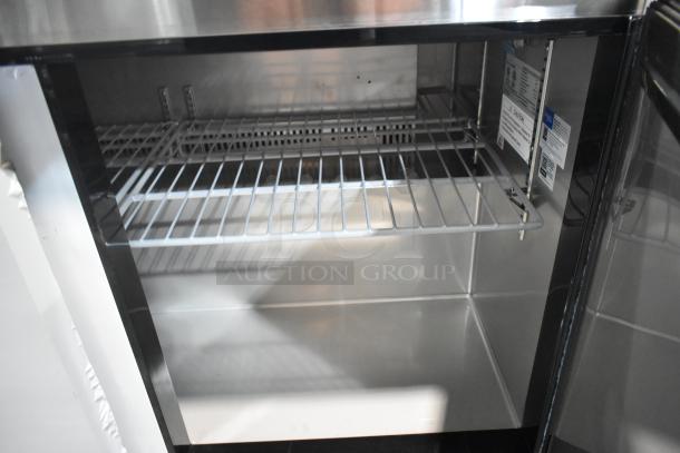 Avantco 178AU48R stainless steel 2-door work top cooler with interior shelving, scratch and dent, on commercial casters. 115V.