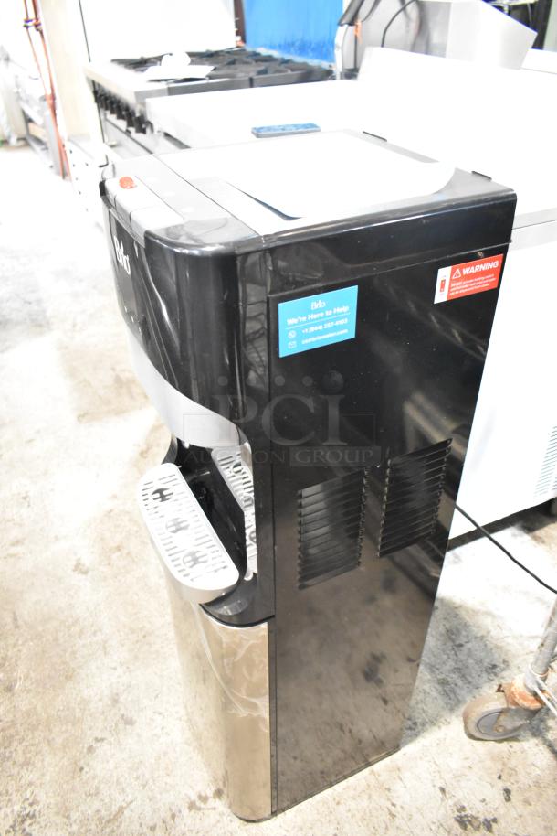 Brio CLBL420V2 water dispenser, black, 115 volts, new condition. Side labels show contact info and safety warning.