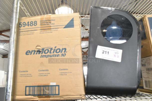 Two Georgia Pacific black poly wall mount paper towel dispensers, model 59488, in original packaging.
