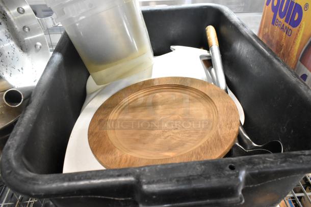 Tier lot including sauce pan, poly bus bin, and wooden dish. Items are mixed in a black container, visible wear on surfaces.