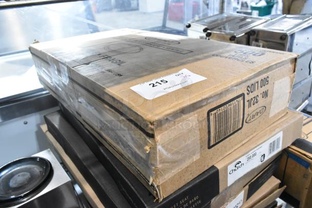 Stack of boxes containing 32JL lids and Church 255 000 toilet seats. Box labeled with auction number 215, quantity 6. Condition appears new.