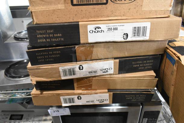 Stack of boxes containing 5 Church 255 000 model toilet seats. Boxes show labels with product information.