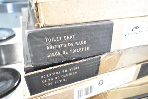 Stacked boxes of Church 255 000 toilet seats and 32JL lids. Visible labels indicate toilet seat in multiple languages.