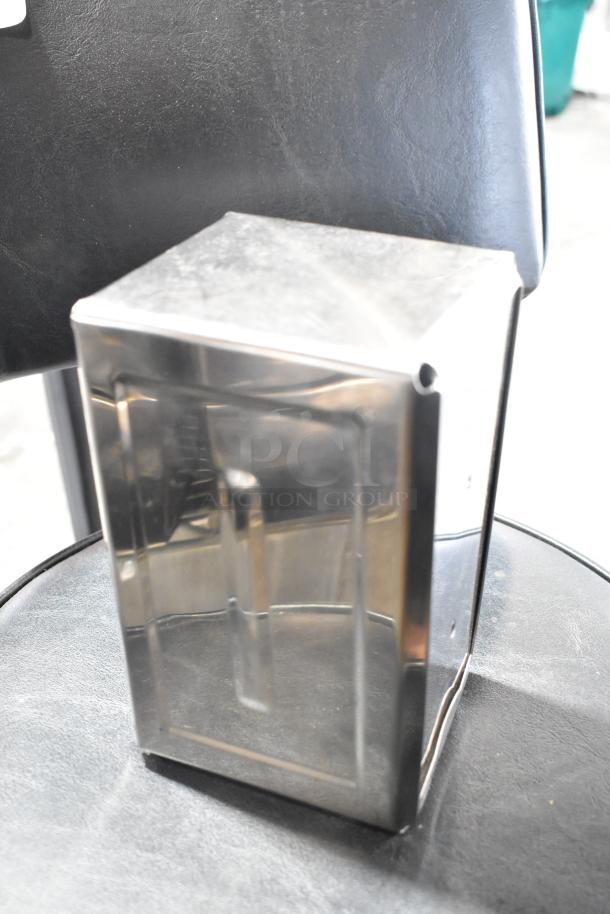 Stainless steel countertop napkin dispenser, sleek design, excellent condition. Auction for 12 units, increasing bid value.