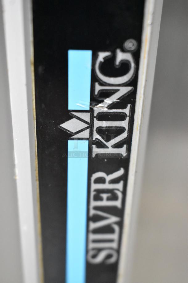 Silver King logo on SKF2A stainless steel commercial prep table, indicating brand and model. Black and blue striped design.