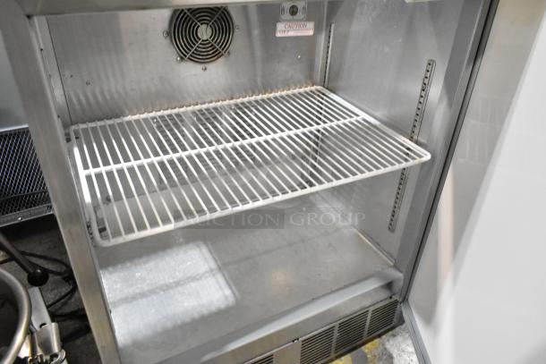 Silver King SKF2A commercial stainless steel prep table, 115 volts, 1 phase, interior wire shelf, caution label visible.