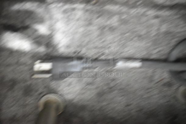 Blurry image of a power cord on a countertop, details of SureShot ACFS-10 dispenser are not visible.