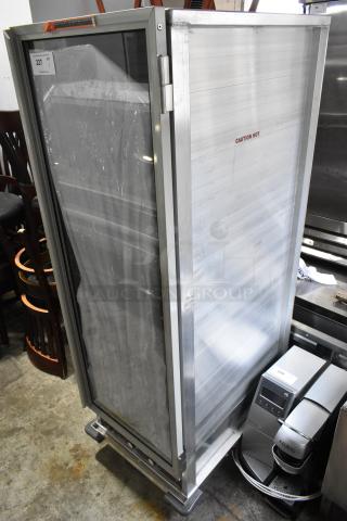 Winholt NHPL-1836CA/LC heated holding cabinet, metal, clear door, 120V, 1 phase, on commercial casters, "Caution Hot" label.