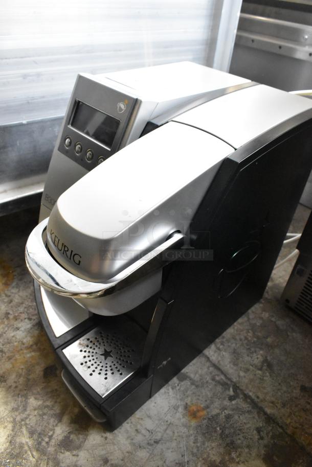 Keurig B3000SE countertop single cup coffee machine, 120 volts, 1 phase, silver and black, minor wear visible.