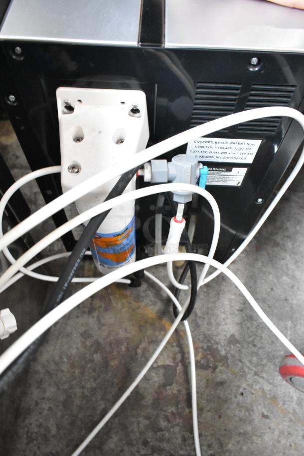 Keurig B3000SE single cup coffee machine, 120 volts, 1 phase. Visible plumbing parts and patent label.
