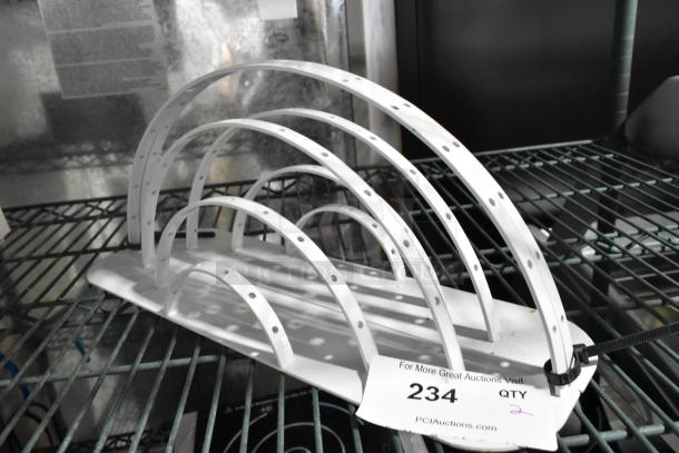 Two white metal arch units with multiple holes, in used condition. Auction tag labeled "234 QTY 2" attached.