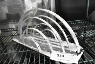 Two white metal arch units with multiple holes, in used condition. Auction tag labeled "234 QTY 2" attached.