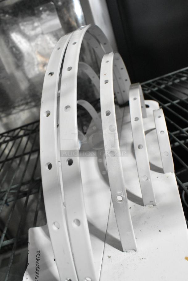 White metal units with circular cutouts, slightly worn. Auction includes two units.