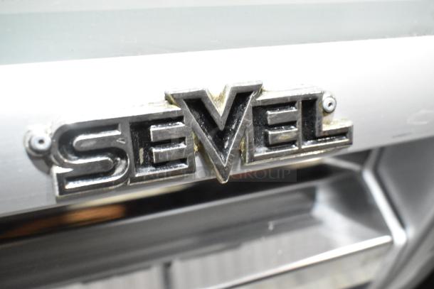 Sevel metal gelato case with stainless steel bins, featuring Sevel logo. 208V, 1 phase, commercial use.