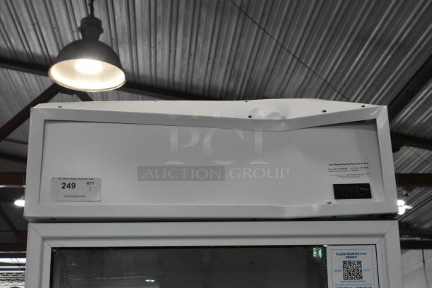 Brand new True TSCI-600R-G-PH single door reach-in cooler, minor dents, poly-coated racks, 115V, warranty label visible.
