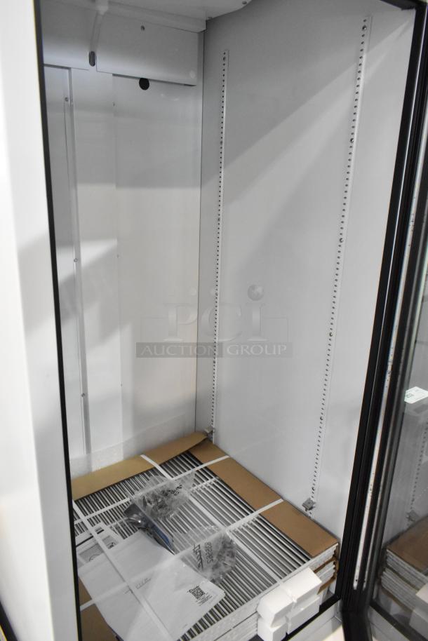 Brand new True TSCI-600R-G-PH commercial cooler with glass door, poly coated racks, 115V, 1 phase; minor scratches.