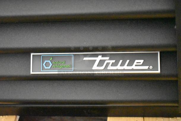 2025 True TVM-48SL-HC metal cooler with 2 doors, natural refrigerant. Logo with “True” and “natural refrigerant” visible.