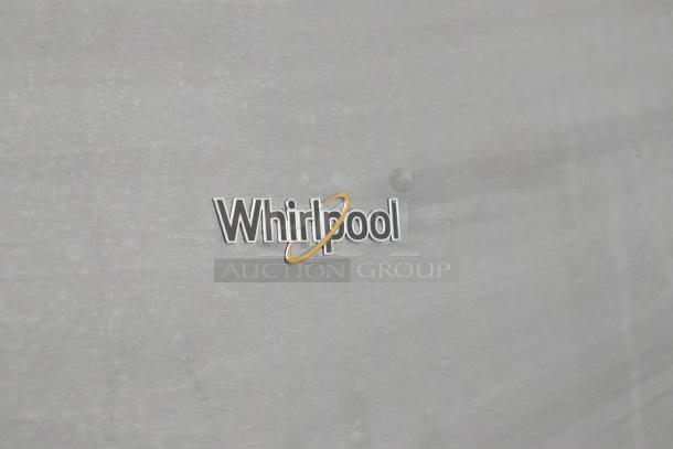 Whirlpool WRT311FZDM05 logo on stainless steel surface, showcasing brand authenticity.