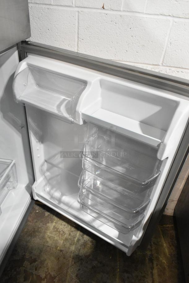 2025 Whirlpool WRT311FZDM05 stainless steel fridge, brand new, scratch and dent. Interior view, clear shelves. 115V, 1 phase.