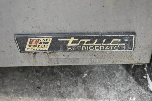 True TUC-27 stainless steel undercounter cooler, single door, on commercial casters, visible True Refrigerator label.